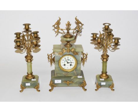 A THREE-PIECE FRENCH GREEN ONYX AND GILT METAL MANTEL CLOCK GARNITURE, the clock case with an urn finial, above a circular de