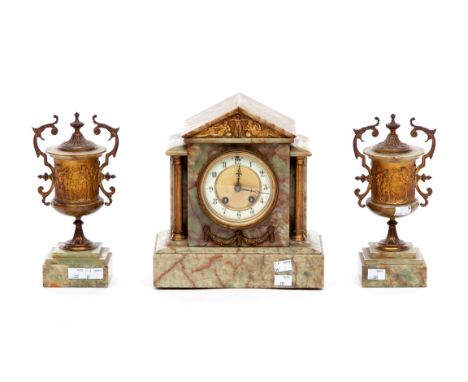 A THREE PIECE GREEN ONYX MANTEL CLOCK GARNITURE, the clock case of architectural design with V shaped top, the clock with cir