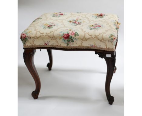 A VICTORIAN SERPENTINE SHAPED ROSEWOOD STOOL, with rectangular padded top, and raised on four cabriole legs, 21" (53cm) wide.