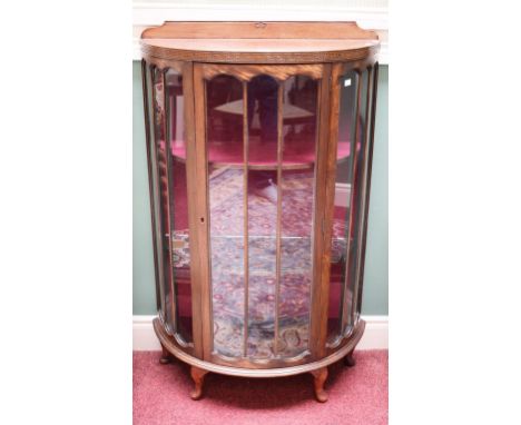 A BOW-FRONTED MAHOGANY CHINA DISPLAY CABINET, in the Gothic style, raised on front cabriole legs, 29" (74cm) wide. (1) 