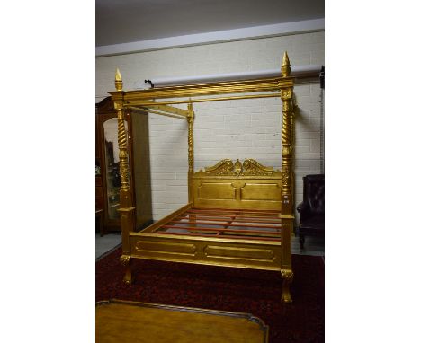 A LARGE ORNATE CHIPPENDALE STYLE GILT FOUR POSTER CANOPY BED, with panelled swan neck head-board and leaf-moulded baluster an