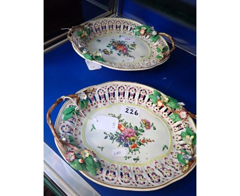 A PAIR OF WORCESTER RETICULATED OVAL DISHES, CIRCA 1780, with naturalistic handles, painted in coloured enamels with a spray 