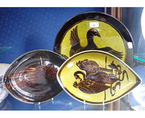POOLE POTTERY: AN 'AEGEAN' CHARGER, shape 5, decorated with a Phoenix, 35cm dia, and two eye dishes (3)