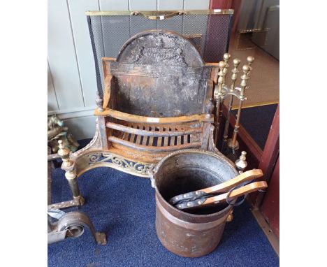 AN ADAM STYLE CAST IRON AND BRASS FIRE GRATE, 57cm high x 63cm wide (overall) with brass fire tools and accessories