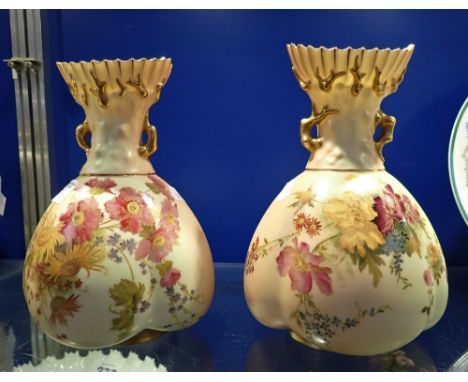 A PAIR OF ROYAL WORCESTER BLUSH IVORY VASES decorated with flowers, 21.5cm high