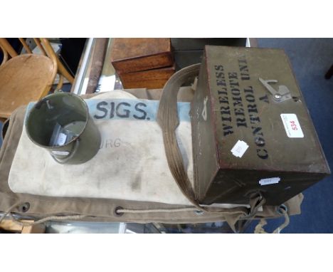 AN ARMY 'WIRELESS REMOTE CONTROL UNIT A' METAL BOX containing some equipment, with two canvas kit bags, a green tin mug and t