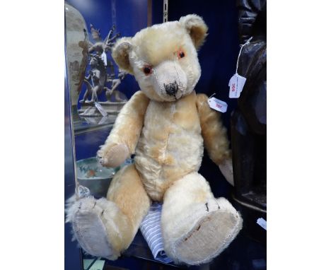 A VINTAGE PLUSH TEDDY BEAR, with jointed limbs, 55cm high, circa 1950s (or earlier) in need of a good loving home