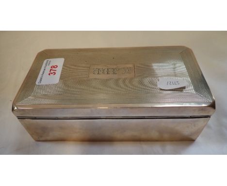 A SILVER ENGINE TURNED CIGARETTE BOX, the cartouche engraved with initials, 16.5cm long (filled)