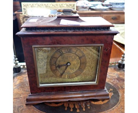 A 1930S MANTEL CLOCK in a bird's eye walnut case, by Finnigans (moulding missing)