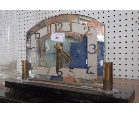 AN ART DECO MANTEL CLOCK with mirrored dial and polished black slate base