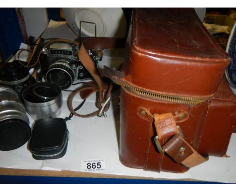 A vintage Exakta camera with lenses and case.