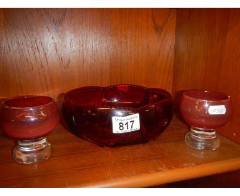 A vintage ruby glass fruit bowl and two footed glasses.