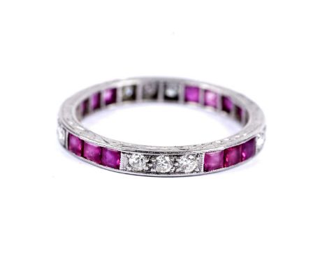 A ruby and diamond eternity ring, set in platinum, stamped "Plat", size O, 3.1g gross.