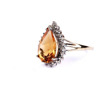 A citrine and diamond ring, the pear cut citrine within a diamond set illusion border, in 9ct yellow gold, size R, 3.1g gross