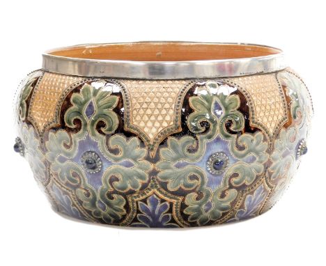 A late 19thC Doulton Lambeth stoneware jardiniere, with silver rim, sgraffito decorated by Frank A Butler with stylised repea
