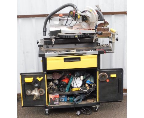 An SIP sliding compound mitre saw, with laser, number 01314, on a table cabinet base, containing further assorted tools.