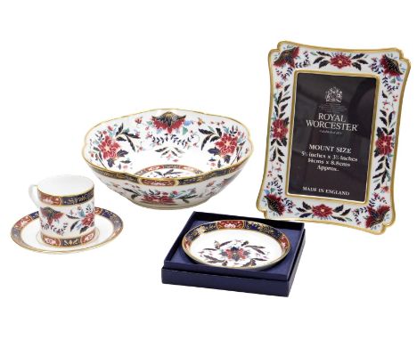 A group of Royal Worcester porcelain in the Prince Regent pattern, comprising a strut photograph frame, coffee can and saucer