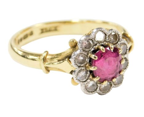 An 18ct gold, ruby and diamond flower head ring, the ruby approx ½ct, diamonds approx ⅓?ct, size O/P, 4.2g.
