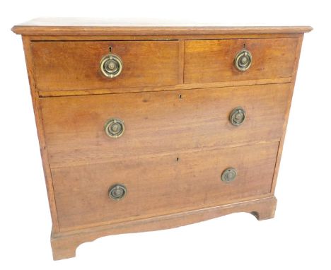 An Edwardian oak chest, of two short over two long drawers, raised on bracket feet, 80cm high, 92cm wide, 51cm deep.
