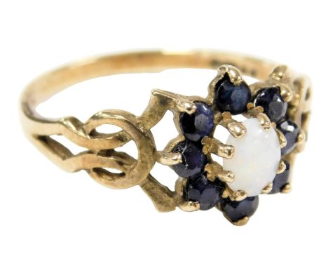 A 9ct gold opal and sapphire ring, in a floral design, with pierced shoulders, size P, 2.0g.