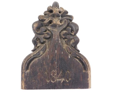 A Victorian oak pew end, with Gothic foliate carving, and dated 1840, 38cm high.