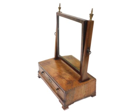 A George III mahogany swing frame toilet mirror, raised on a rectangular box base, with singular frieze draw, on bracket feet