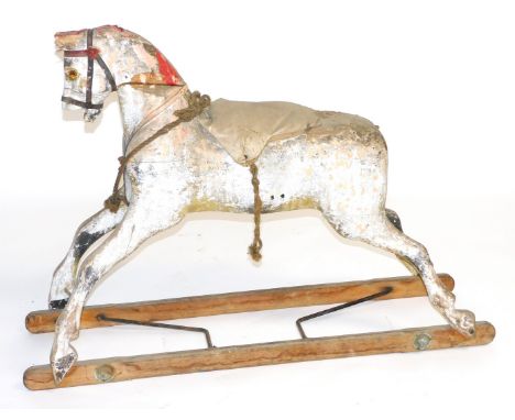 A vintage red and white painted wooden rocking horse, 122cm wide.