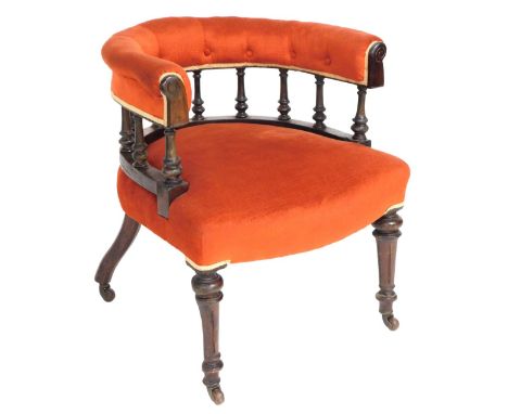 A Victorian mahogany tub armchair, upholstered in button back and overstuffed orange fabric, with a galleried rail, raised on