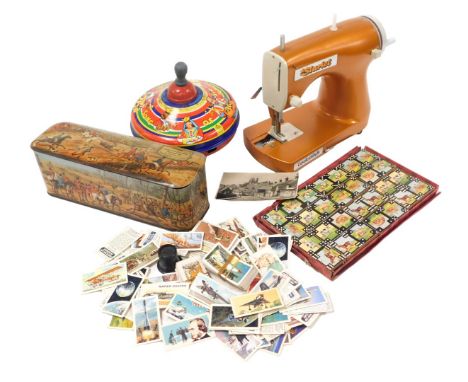 A Chad Valley tin plate humming top, Starlet lock stitch child's sewing machine, set of dominoes decorated with animals, and 