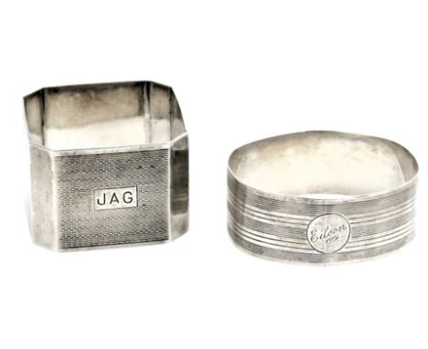 A George VI silver napkin ring, with engine turned decoration, reserve monogram engraved, Chester 1945, and an oval napkin ri