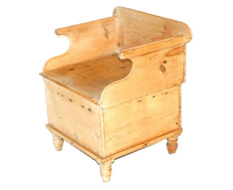 A Victorian pine commode, with a hinged lid opening to reveal a china bowl inset, raised on turned feet, 64cm high, 48cm wide