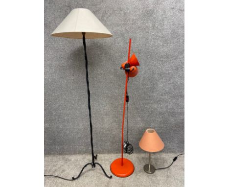 Three lamps to include a cast iron floor lamp with a twisted stem on tripod supports with shade, a mid-century floor lamp wit