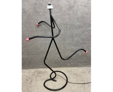 A 1950's running man figural lamp made from steel tubing with bakelite terminals, as illustrated in the 'Fifties Source Book'