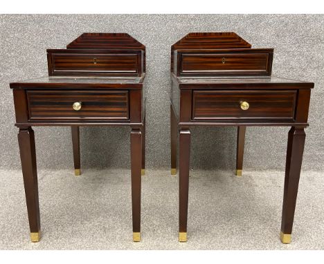 A pair of contemporary zebrawood bedside tables of stepped form, the very top being a lamp stand with a cable tidy above a si
