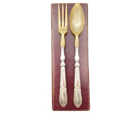 An embossed white metal and horn salad serving fork and spoon with indistinct stamps to the handles. In a fitted leather case