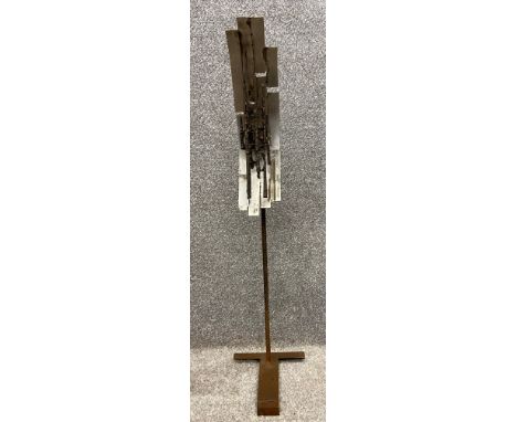 A mid-century Constructivist style abstract sculpture by Robert De Quin with welded upright steel rods floating against a cur