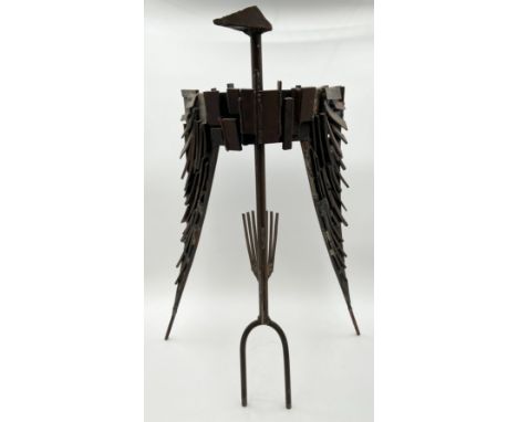 A mid-century abstract figural sculpture of a bird with spread wings made with sheet metal and steel rods, by Robert De Quin.