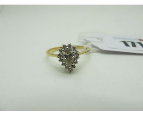 A Pear Shape Single Stone Diamond Ring, the (6.5mm long) stone claw set within border of uniform brilliant cut diamonds, betw