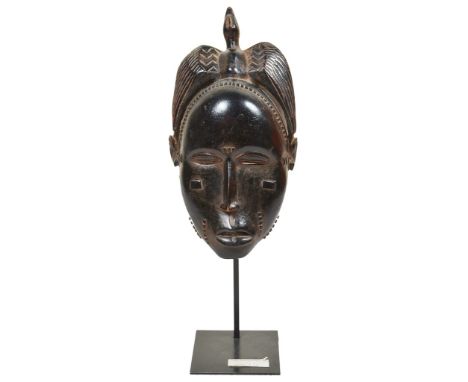 African Tribal Portrait Mask: In the form of a woman with a bird to the top, features realistically carved with scarification