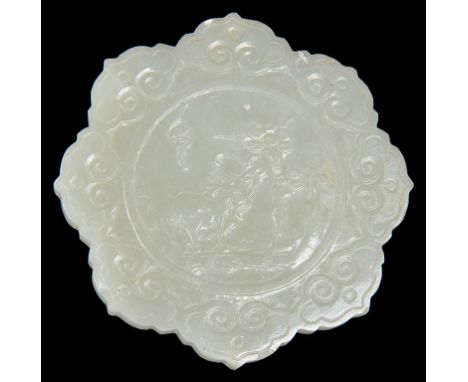 A small Chinese jade carving19th centuryOf a light celadon tone. In the shape of a petalled medallion. Carefully carved with 