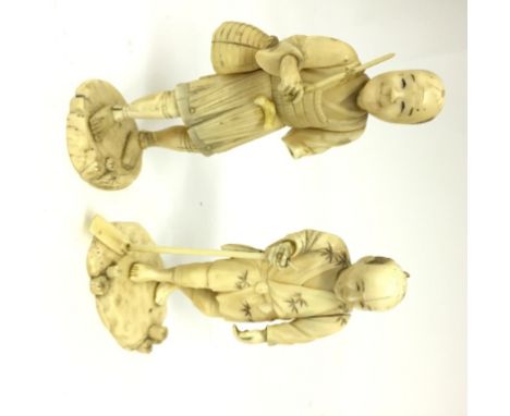 A Meiji Period Ivory Okimono:Two carvings of peasants one with an adze, the other carrying a bag.Heights 13 cm and 12 cm