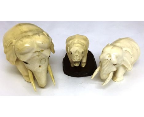 Three Meiji Period Ivory Animals:Two elephants one with set gold toes and eyes and a Rhinocerous on wooden base larges elepha