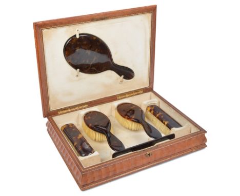 A Tortoiseshell Dressing Set in Leathered Box:A six-piece tortoiseshell dressing set comprising two hand brushes, two brushes