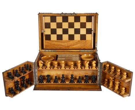 A Walnut Boxed Games Compendium:To include chess, draughts, backgammon, dominoes, the box being decorated with metalwork