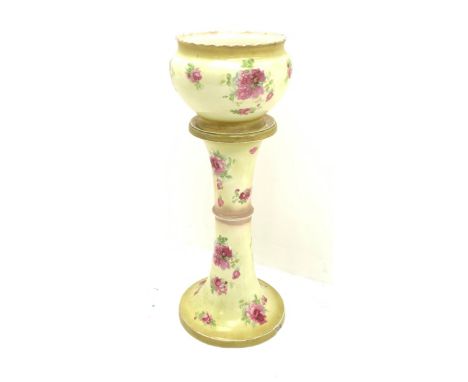 An early 20th century ceramic jardini�re on stand, each decorated with pink roses upon a yellow ground, overall H93cm.Click h
