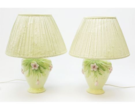 A pair of Italian ceramic lamps, of baluster form, the light green glaze detailed with pink flowers, with pleated light green