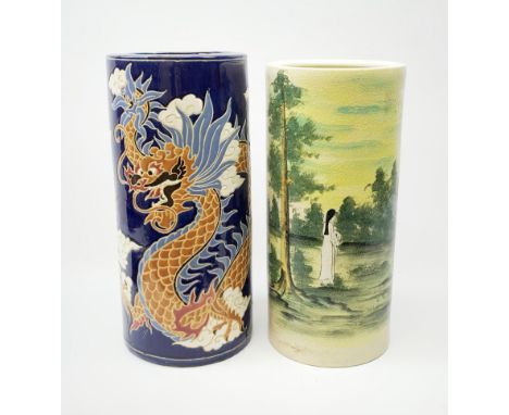 Two ceramic stick stands, the first example decorated with two Chinese dragons chasing a flaming pearl amidst auspicious clou