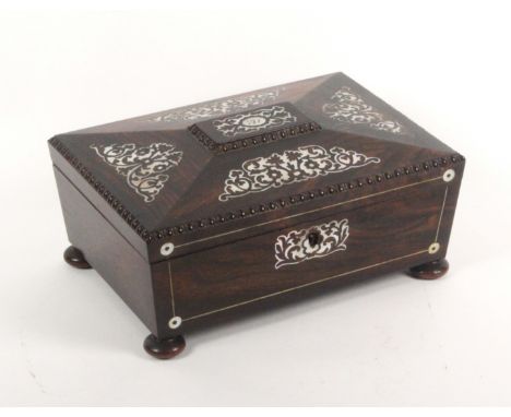 A mid Victorian rosewood and cut mother of pearl sewing box of sarcophagal form, attractively fitted, the box on rosewood bun