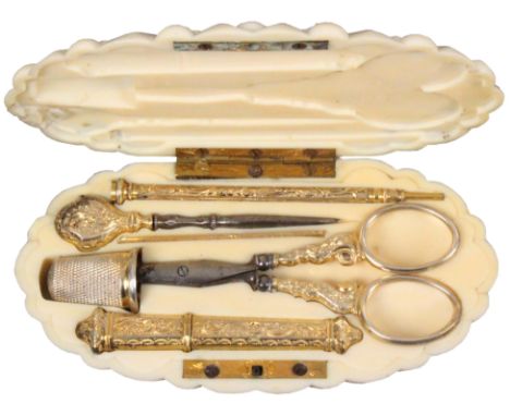 A good French oval ivory etui with a full complement of fittings, circa 1860, the lid deeply carved with balls and grooves, o