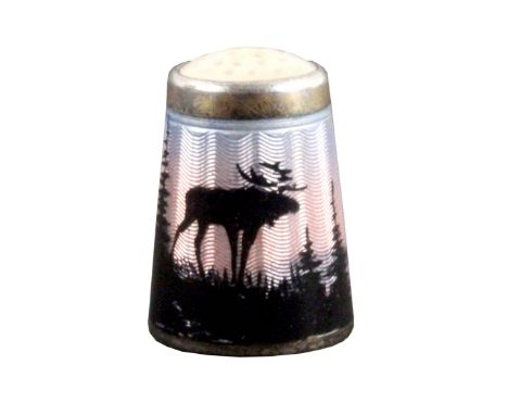 A Norwegian silver and enamel thimble, depicting a reindeer in a forest by a fjord and island with midnight sun, below a moon